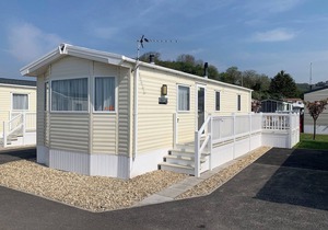 Modern and contemporary 12ft-wide caravan with one double and two twin.