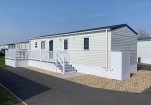 Modern and contemporary 12ft-wide caravan with one double and two twin.