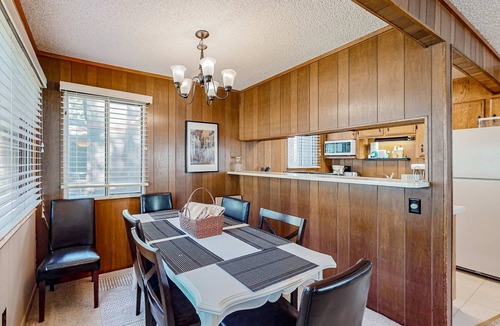 Tahoe Island Cabin | Classic central cabin near river with large tree-lined deck, grassy yard & gym