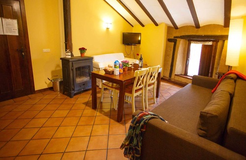 Robregordo Ski Chalet | Comfortable bedroom apartment sofa bed and fireplace on the first floor
