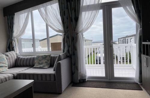 Hamworthy House | Rambling Rose caravan with sea view on Rockley Park