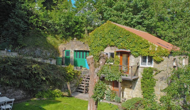 Pretty two storey holiday cottage right beside the village stream.